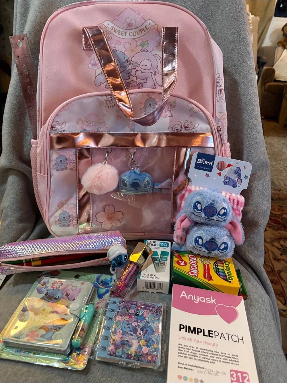 Disney Pink Lilo & Stitch Kids Backpack with Plush Charms and school supplies.